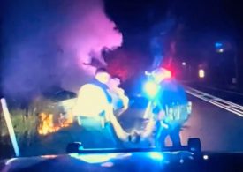 Heartstopping moment hero cops smash window & drag unconscious driver out with SECONDS to spare before flames engulf car