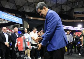 Awkward moment Venezuela tyrant Maduro salsas with robot as US flies special operations troops into Caribbean