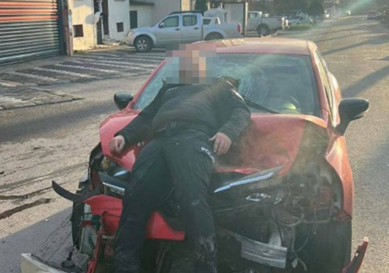 Shock pic shows cop lying unconscious on battered car when driver stopped to take a PHOTO moments after mowing him down