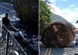 Terrifying moment locals run for their lives as giant boulder rolls down road & crushes motorbike after falling off hill
