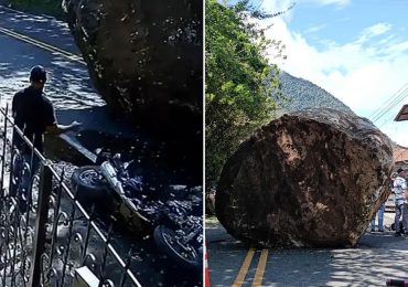 Terrifying moment locals run for their lives as giant boulder rolls down road & crushes motorbike after falling off hill