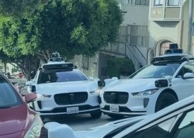 Excruciating moment three self-driving taxis clog up street and stop moving after getting into AI standoff