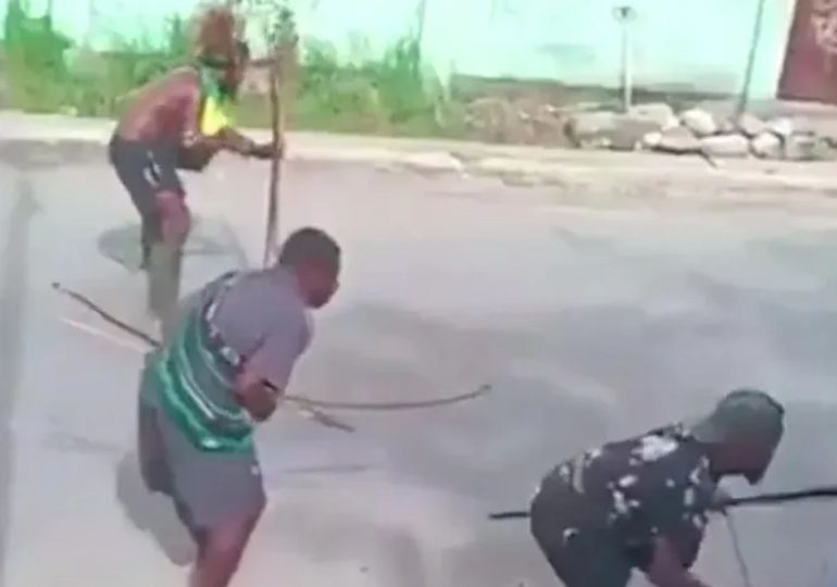 Shocking moment bow and arrow fight erupts in the middle of busy street between rival tribes using ancient weapons
