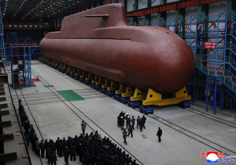 North Korea unveils HUGE nuclear-powered submarine as Kim Jong Un oversees long-range missile launch