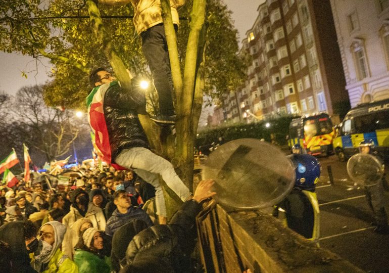 Hundreds gather outside Iran embassy in London after flag torn down & protests spread around world