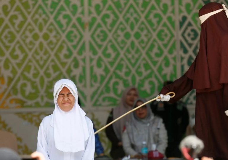 Brutal moment woman FAINTS after being lashed 140 times in agonising Sharia punishment for having sex outside marriage