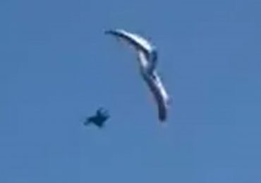 Heart-stopping moment paraglider plunges into sea after losing control 500ft in the air in front of horrified beachgoers
