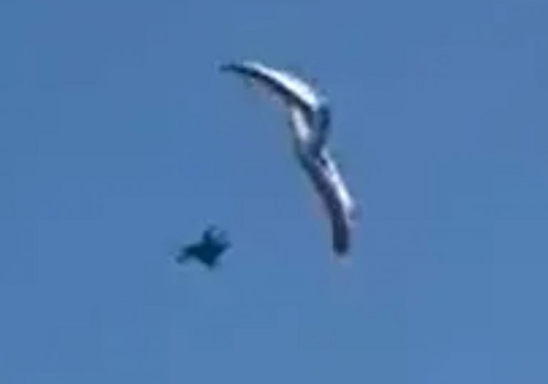 Heart-stopping moment paraglider plunges into sea after losing control 500ft in the air in front of horrified beachgoers