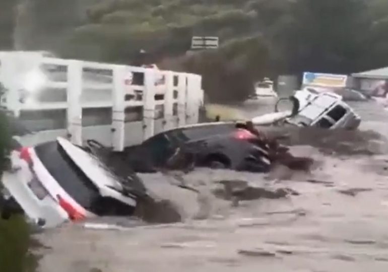 Dramatic moment dozens of cars are swept out to SEA as horror flash floods hit Australia leaving thousands without power