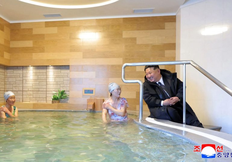 Bizarre moment Kim Jong-un visits bathers in steamy spa & even tests the water – while keeping his heavy winter coat on