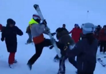 Moment snowboarders & skier brawl in the snow on mountain slope after argument breaks out following crash