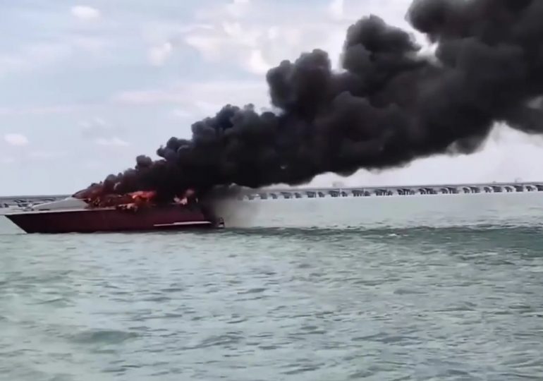 Dramatic moment luxury yacht explodes in fireball forcing captain and crew to leap into sea as vessel burns to a crisp
