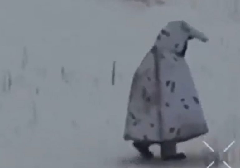 Moment desperate Russian soldier who looks like a PENGUIN in bizarre anti-drone disguise is blitzed on battlefield