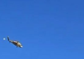 Terrifying moment helicopter being flown by second chopper breaks free and falls to the ground after harness failed