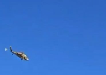 Terrifying moment helicopter being flown by second chopper breaks free and falls to the ground after harness failed