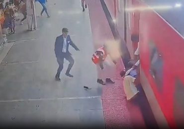 Horrifying moment father and young son are dragged by moving train as desperate onlookers try to rescue them