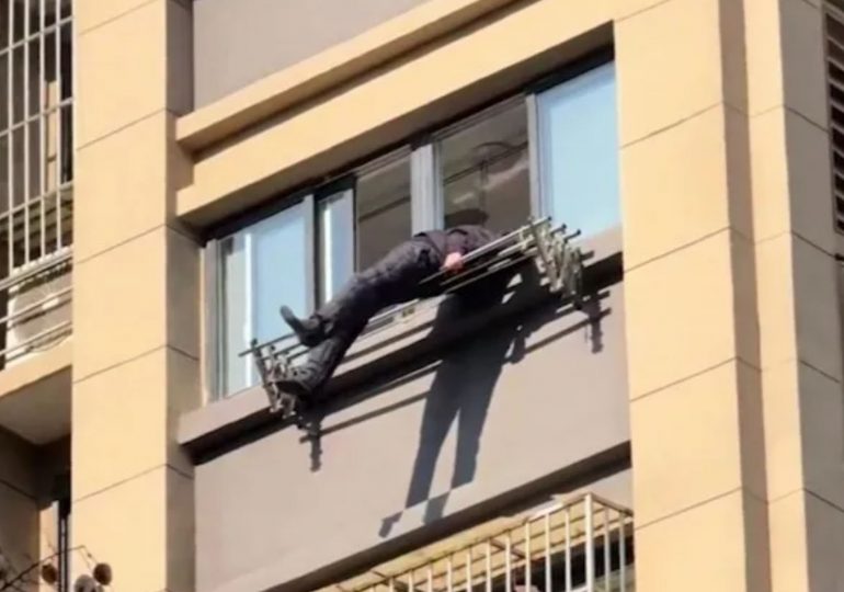 Shock moment elderly man plunges from 15th floor and is miraculously saved by clothing rail hanging from flat window