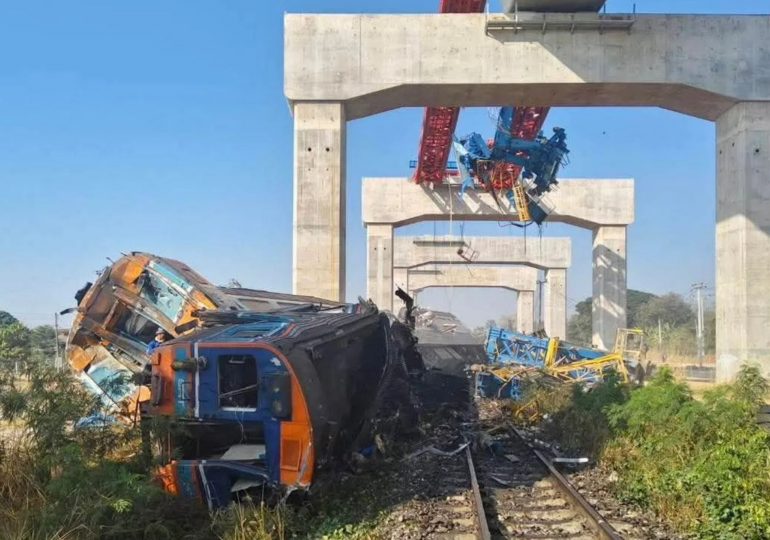 At least 22 dead and 80 injured after a crane collapses and smashes through a moving train in Thailand sparking a fire