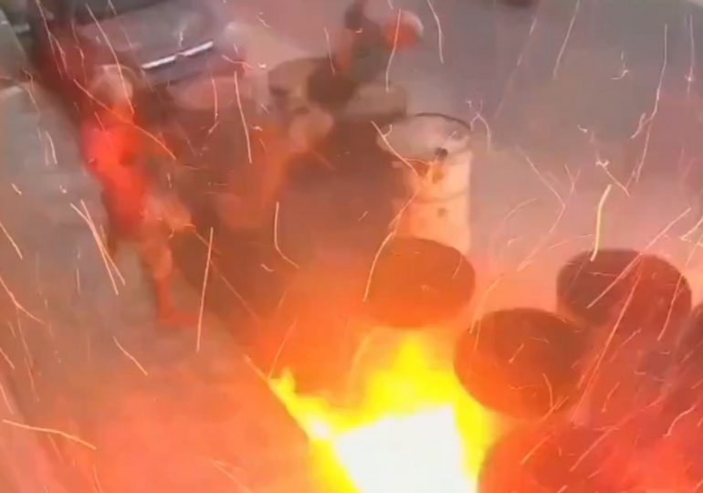 Shocking moment two youths blow themselves up after clicking lighter over oil drum – sending them flying into the air
