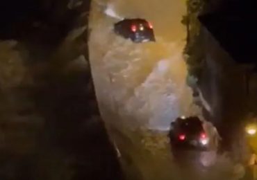 Dramatic moment huge waves smash into cars driving along coastal road as panicked motorists try to flee floodwater