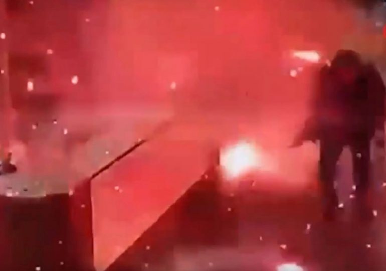 Terrifying moment parcel explodes in apartment reception just after being delivered to desk as two injured