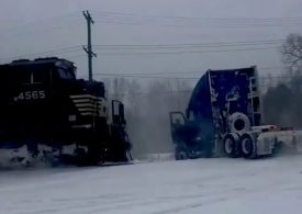Heart-stopping moment train smashes into a truck stuck on the rail line after a ‘bomb cyclone’ snowstorm
