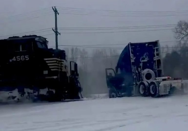 Heart-stopping moment train smashes into a truck stuck on the rail line after a ‘bomb cyclone’ snowstorm