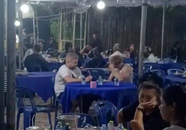 Awkward moment backpackers gatecrash Thai funeral thinking it’s a restaurant – even grabbing a table & looking for menu