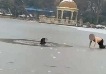 Moment hero dad dives into freezing lake to save stranger’s son after boy plunged through ice while playing with pals