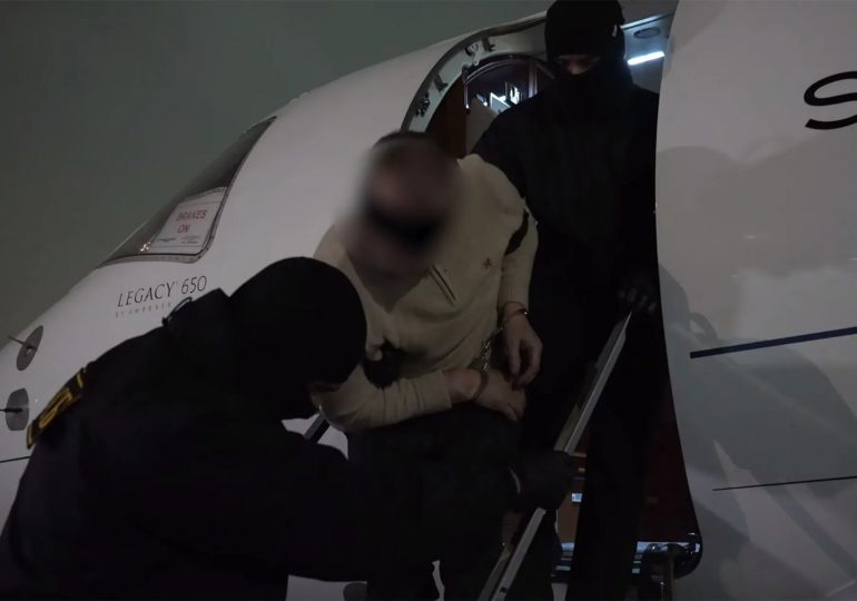 Moment ‘hitman who shot Putin’s spy chief’ is bundled into van as he’s taken for interrogation after fleeing to Dubai