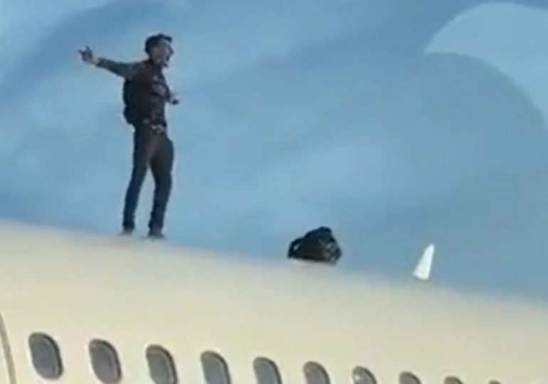 Watch shocking moment man climbs on airplane’s roof at Spanish holiday hotspot airport causing two-hour flight delay